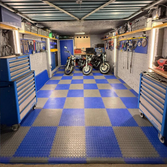Well-organised workshop garage with blue and grey Duramat chequered floor tiles and tool cabinets